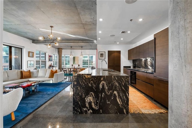 kitchen featuring concrete flooring, oven, a sink, and modern cabinets