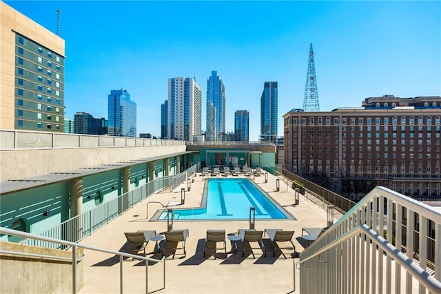 pool with a city view and a patio