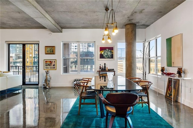 dining area with finished concrete flooring and baseboards