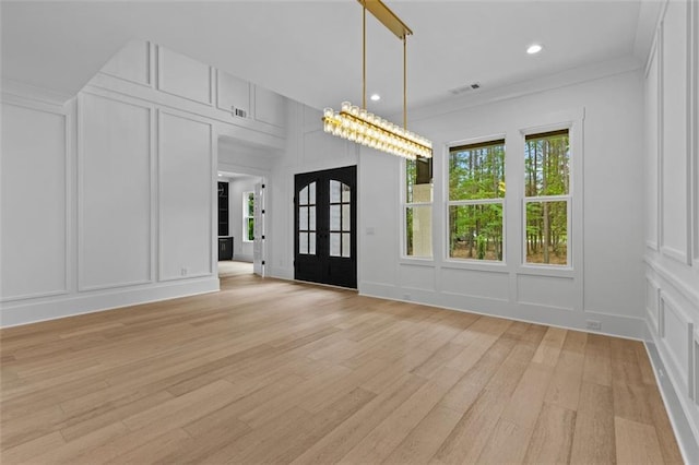 interior space with visible vents, recessed lighting, a decorative wall, and light wood-type flooring