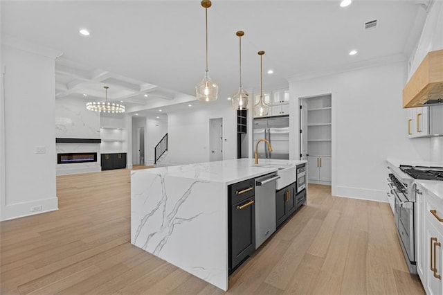 kitchen with high quality appliances, a sink, light wood finished floors, coffered ceiling, and recessed lighting