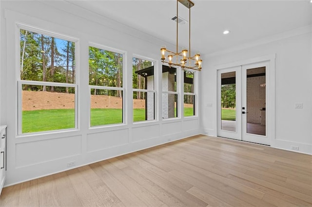 unfurnished sunroom with visible vents, french doors, and a chandelier
