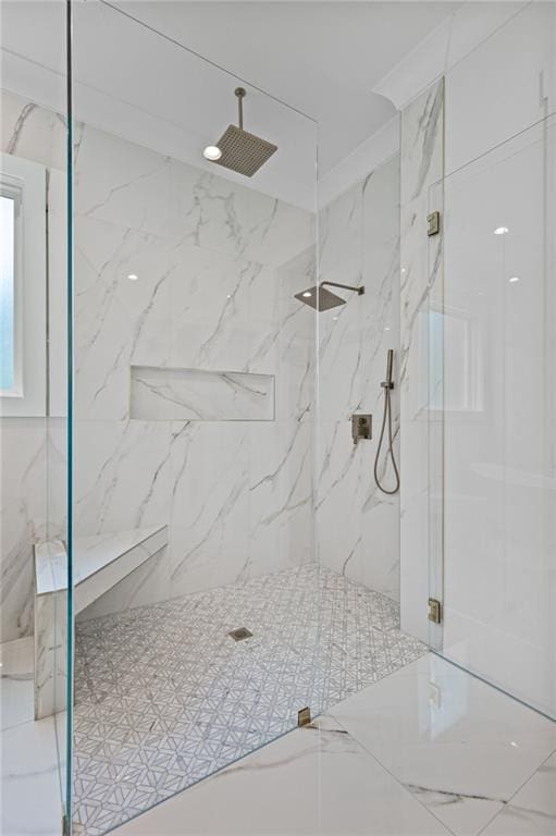 full bathroom featuring a marble finish shower