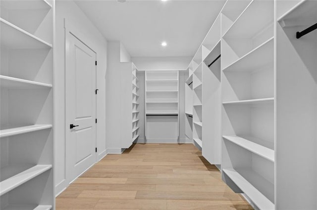 walk in closet featuring wood finished floors