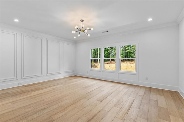 spare room with crown molding, a chandelier, recessed lighting, light wood-type flooring, and visible vents