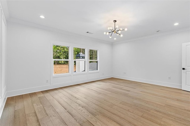 spare room with a notable chandelier, light wood-style floors, recessed lighting, baseboards, and ornamental molding