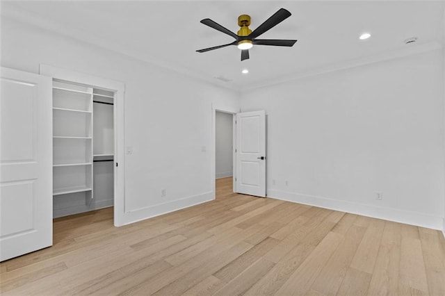 unfurnished bedroom with recessed lighting, baseboards, a spacious closet, and light wood-style flooring