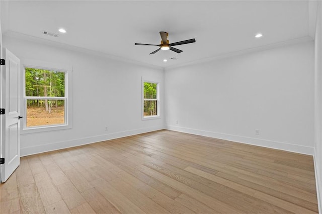 empty room featuring baseboards, a ceiling fan, light wood finished floors, and a wealth of natural light