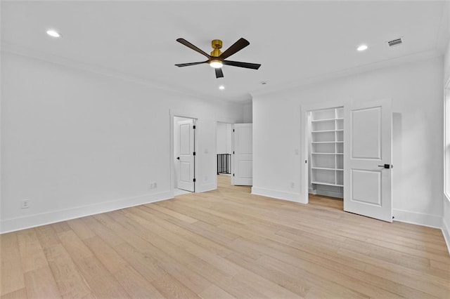 unfurnished bedroom with visible vents, light wood-style floors, a walk in closet, and baseboards