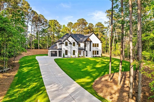 view of front facade featuring concrete driveway, a garage, and a front lawn