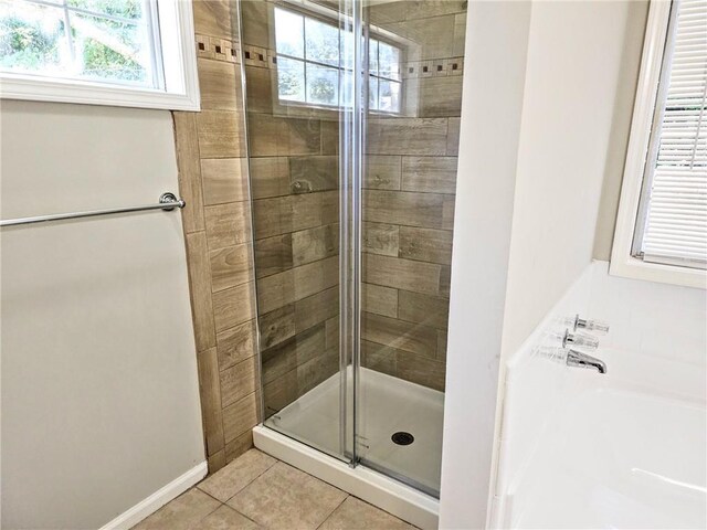4093 Chapel Mill Bnd, Decatur, GA 30034 - bathroom featuring a bath, tile patterned flooring, a shower stall, and plenty of natural light