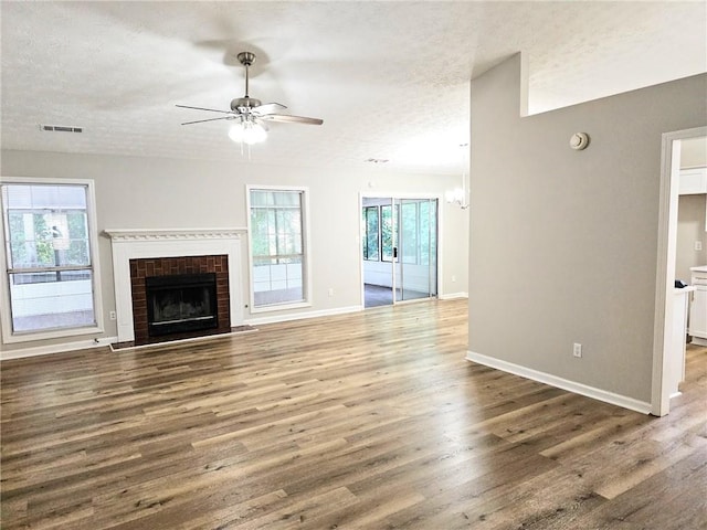 4093 Chapel Mill Bnd, Decatur, GA 30034 - unfurnished living room with a textured ceiling, visible vents, baseboards, wood finished floors, and ceiling fan with notable chandelier