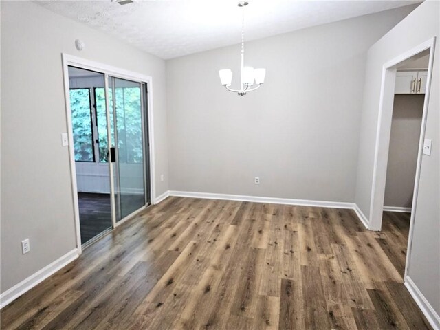 4093 Chapel Mill Bnd, Decatur, GA 30034 - unfurnished dining area with baseboards, wood finished floors, and a chandelier