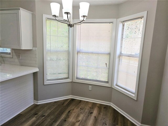 4093 Chapel Mill Bnd, Decatur, GA 30034 - unfurnished dining area featuring dark wood finished floors, a notable chandelier, baseboards, and a wealth of natural light