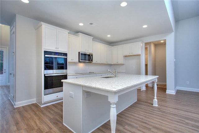 135 Applewood Way, Homer, GA 30547 - kitchen with sink, wood-type flooring, a center island with sink, stainless steel appliances, and white cabinets