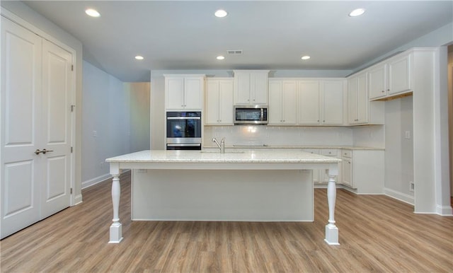 135 Applewood Way, Homer, GA 30547 - kitchen with stainless steel appliances, a kitchen island with sink, and white cabinets