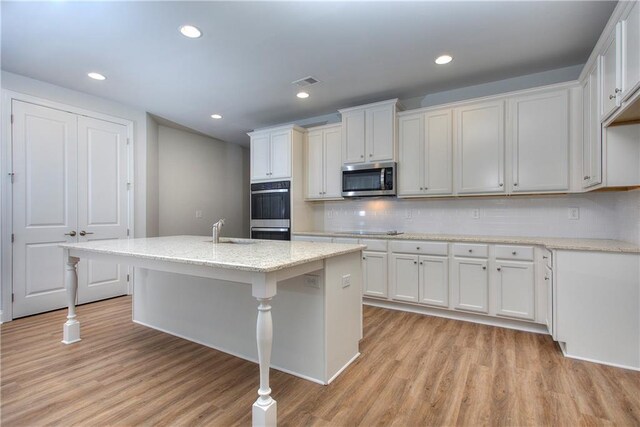 135 Applewood Way, Homer, GA 30547 - kitchen featuring appliances with stainless steel finishes, sink, an island with sink, and white cabinets