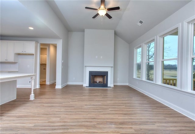 135 Applewood Way, Homer, GA 30547 - unfurnished living room with ceiling fan, lofted ceiling, built in desk, and light wood-type flooring
