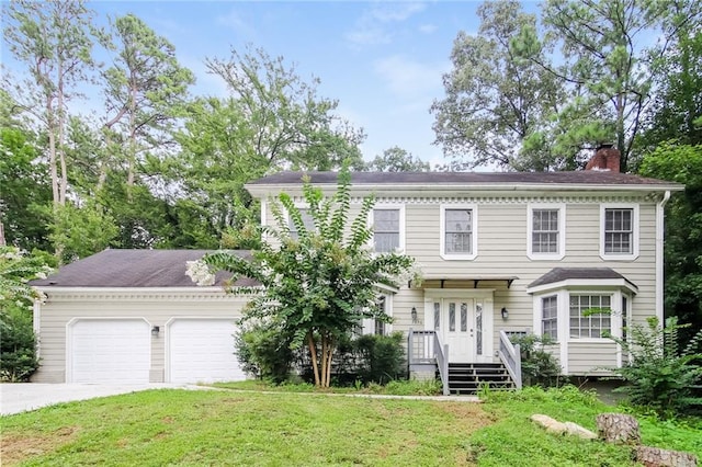 view of front of home featuring a garage and a front yard