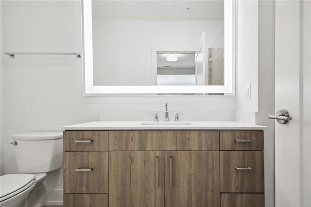 bathroom featuring toilet and vanity