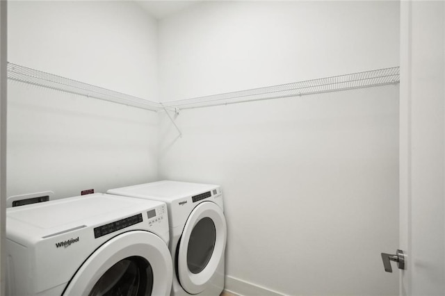 clothes washing area with laundry area and washer and dryer