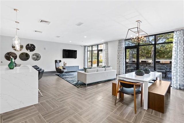 interior space with floor to ceiling windows, visible vents, and recessed lighting