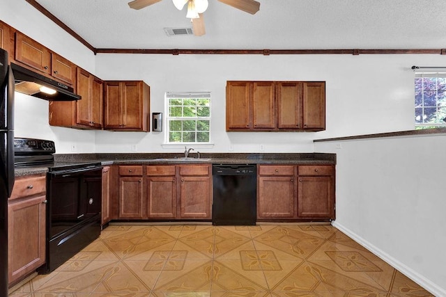 kitchen featuring ceiling fan, dark countertops, a sink, black appliances, and under cabinet range hood