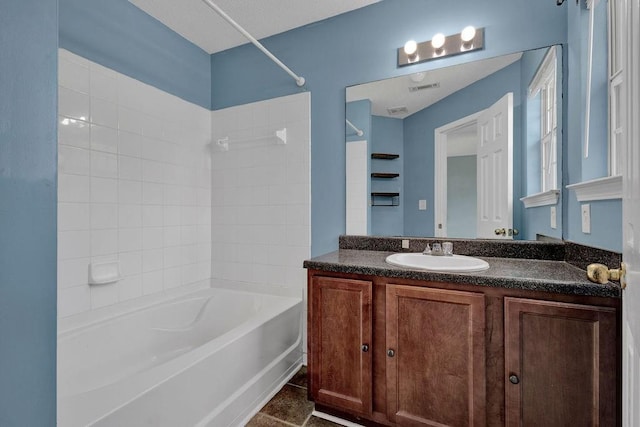 bathroom with vanity, shower / bathing tub combination, and visible vents