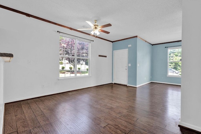 unfurnished room featuring ceiling fan, a textured ceiling, baseboards, wood finished floors, and ornamental molding