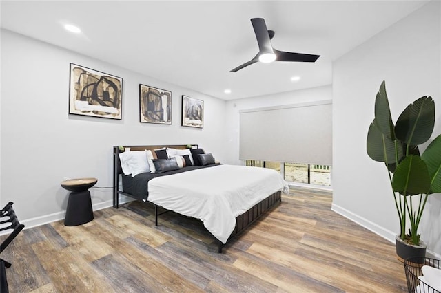 bedroom with ceiling fan and hardwood / wood-style flooring