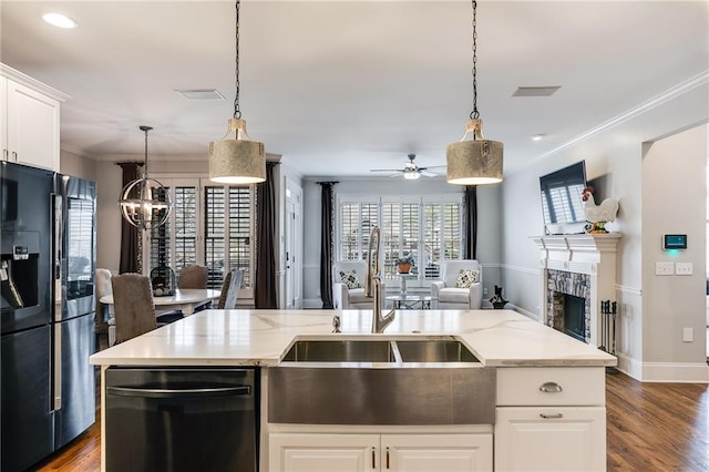 kitchen featuring dishwashing machine, a fireplace, ornamental molding, open floor plan, and black refrigerator with ice dispenser