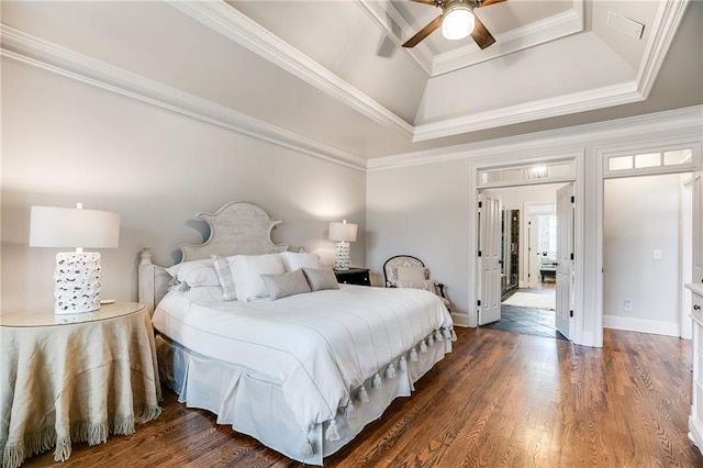 bedroom featuring a raised ceiling, ornamental molding, baseboards, ceiling fan, and dark wood-style flooring