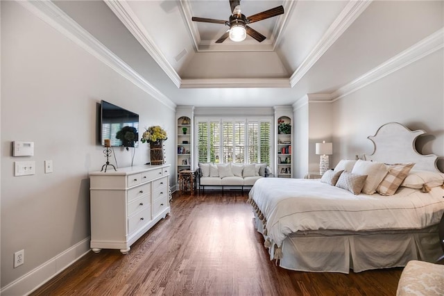 bedroom with baseboards, a raised ceiling, dark wood-type flooring, and crown molding