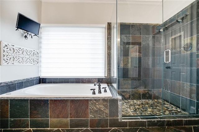 bathroom featuring a bath and a stall shower