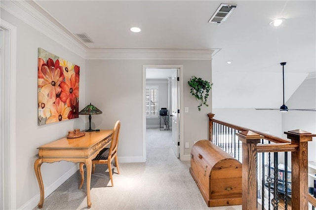 home office with visible vents, light carpet, baseboards, and crown molding