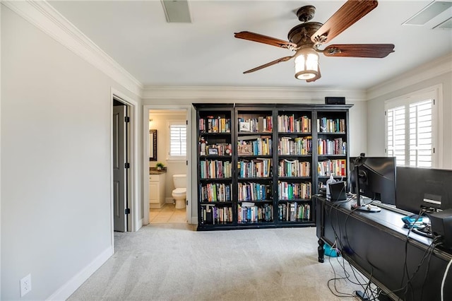 home office featuring baseboards, carpet floors, a ceiling fan, and crown molding