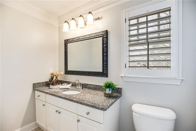 half bathroom with vanity, toilet, a wealth of natural light, and ornamental molding