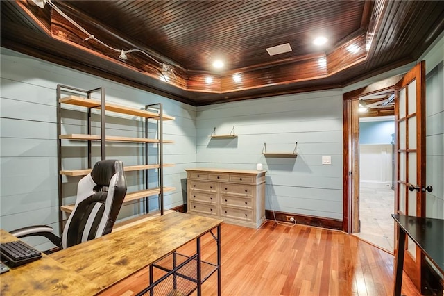 office space with wooden ceiling, wood finished floors, a tray ceiling, and ornamental molding