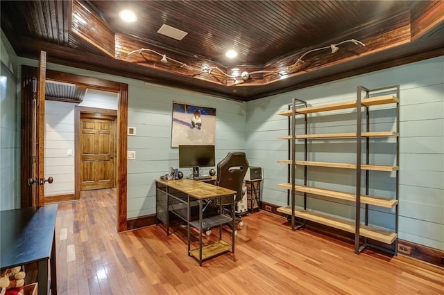 office featuring a tray ceiling, wood ceiling, and wood finished floors