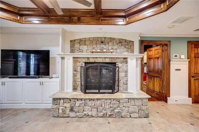 room details featuring visible vents, beam ceiling, coffered ceiling, and a stone fireplace