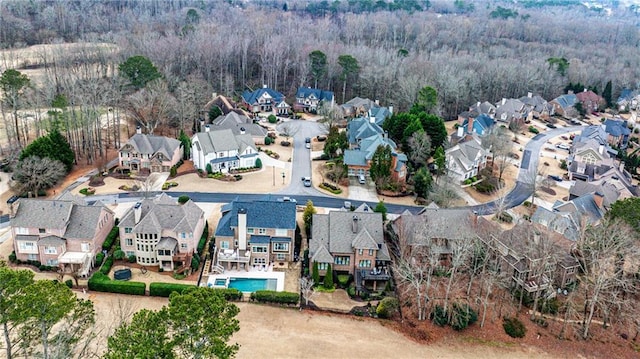 drone / aerial view featuring a forest view and a residential view