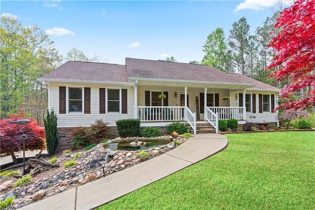 single story home featuring a front lawn and covered porch