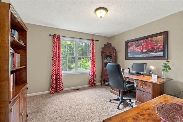 office space with light carpet and a textured ceiling