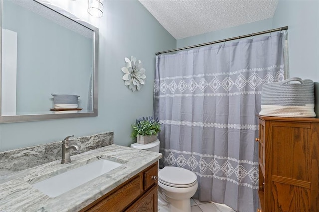 bathroom with tile patterned flooring, vanity, a textured ceiling, and toilet