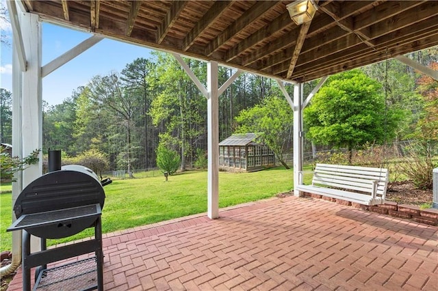 view of patio featuring an outbuilding