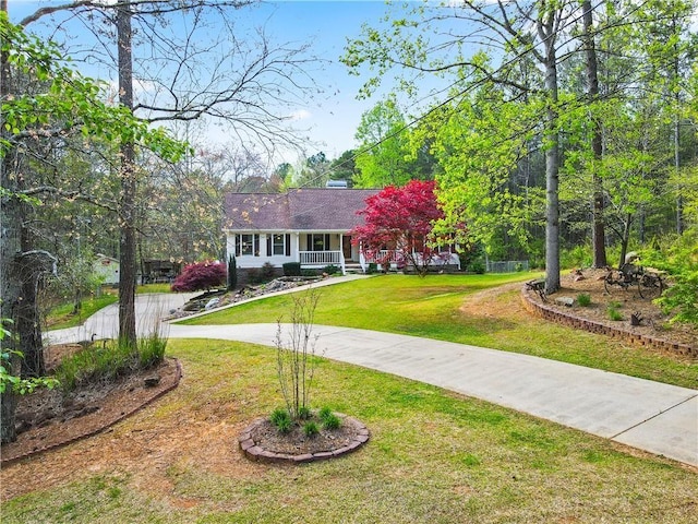 ranch-style home with covered porch and a front lawn