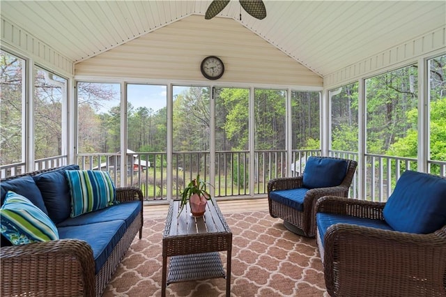 sunroom with ceiling fan, a healthy amount of sunlight, and vaulted ceiling