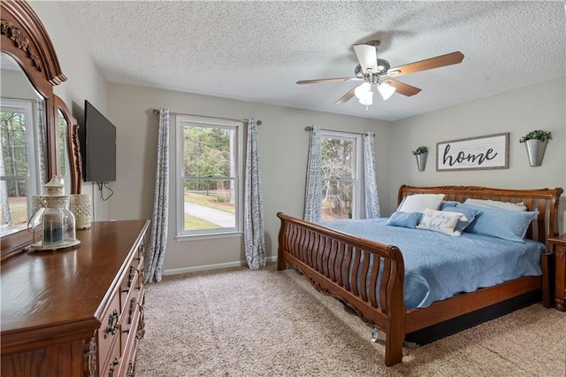 bedroom featuring light carpet, a textured ceiling, and ceiling fan