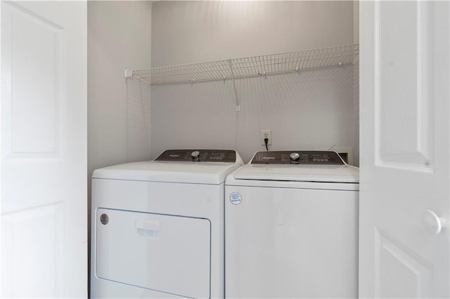 clothes washing area featuring washer and dryer