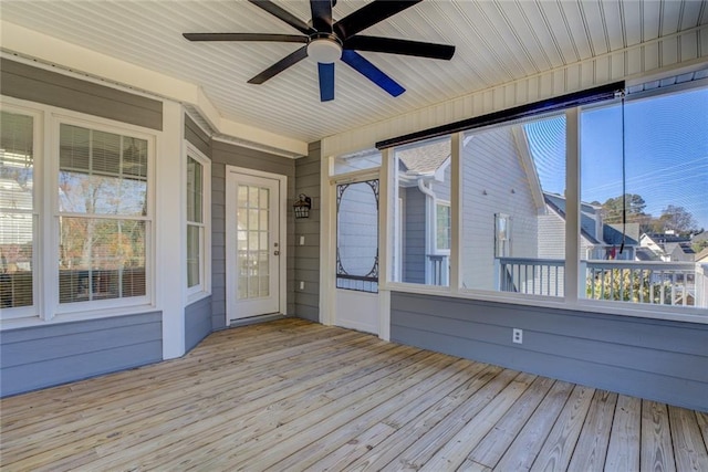 unfurnished sunroom with plenty of natural light and ceiling fan